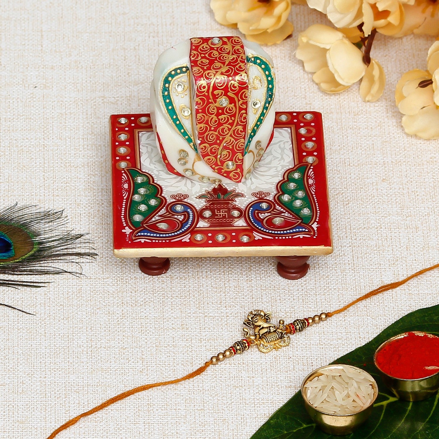 Designer Ganesha Playing Dholak Rakhi with Lord Ganesha on Marble Chowki and Roli Chawal Pack