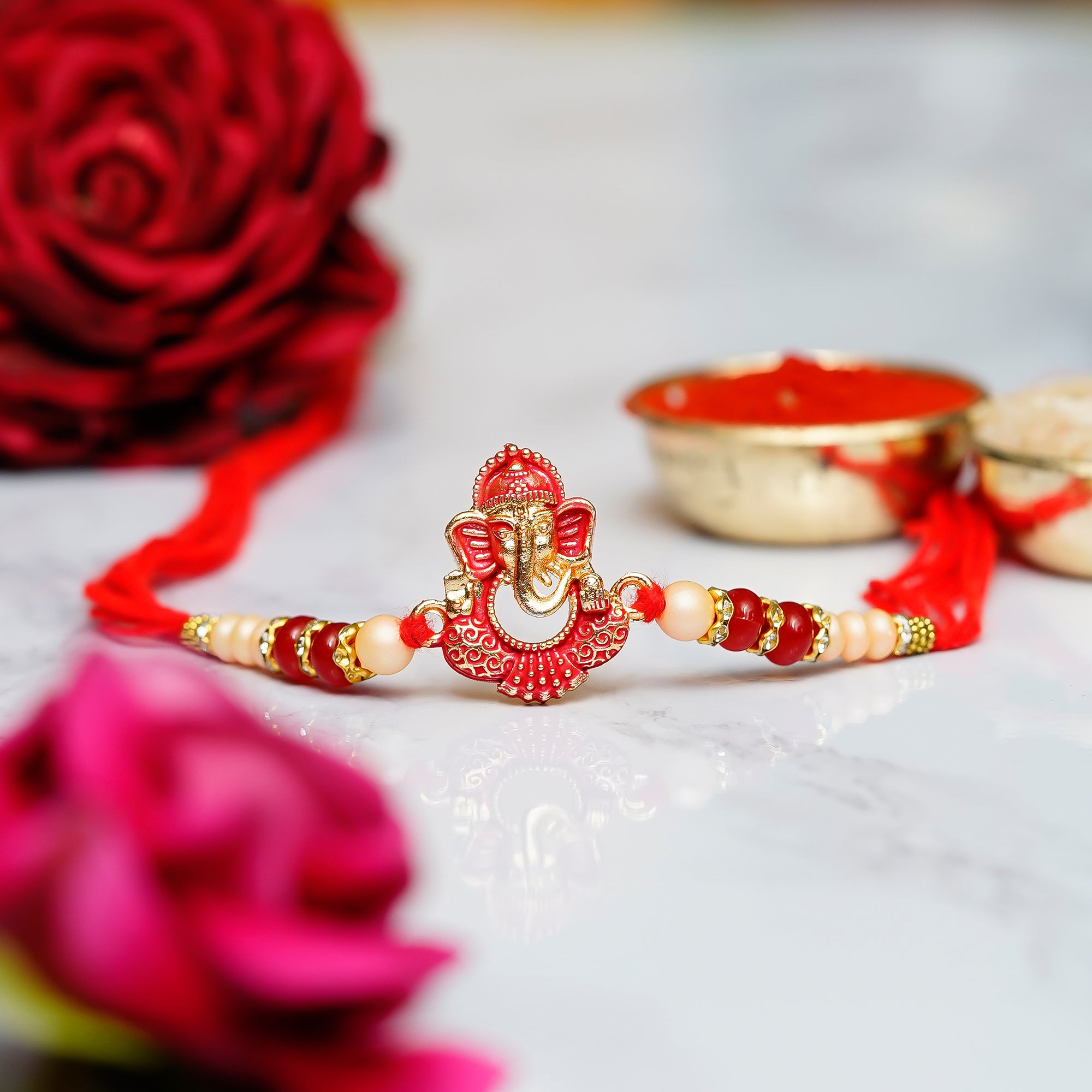 Designer Ganesha Rakhi with Lord Ganesha reading Book on Wooden Chair and Roli Chawal Pack 1