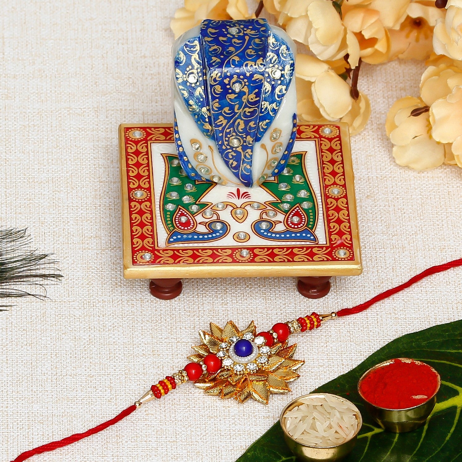 Designer Gota Patti Rakhi with Lord Ganesha on Marble Chowki and Roli Chawal Pack