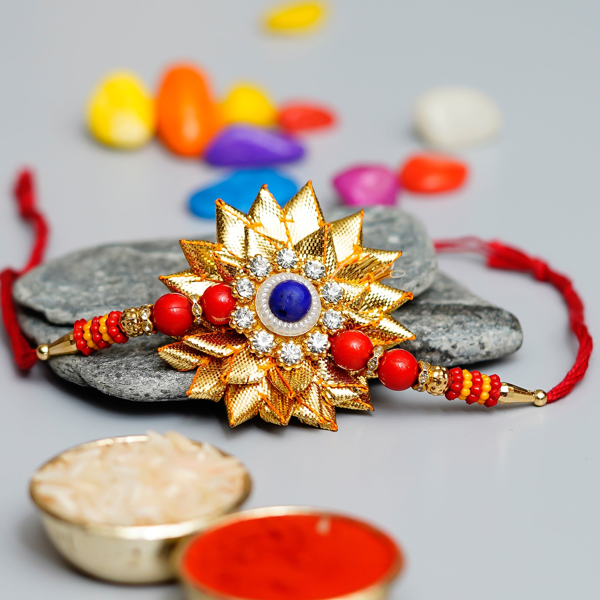 Designer Gota Patti Rakhi with Lord Ganesha reading Book on Wooden Chair and Roli Chawal Pack 1