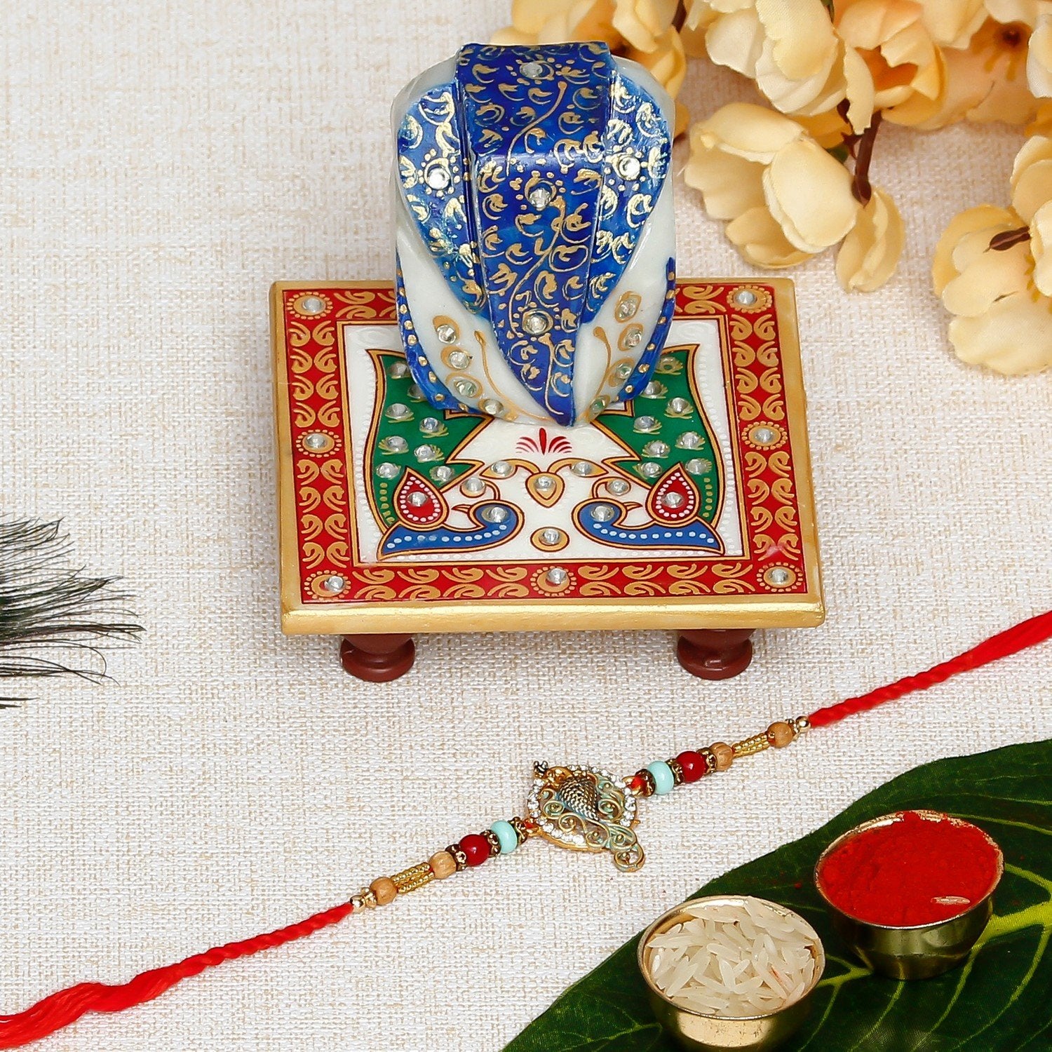 Designer Peacock Rakhi with Lord Ganesha on Marble Chowki and Roli Chawal Pack
