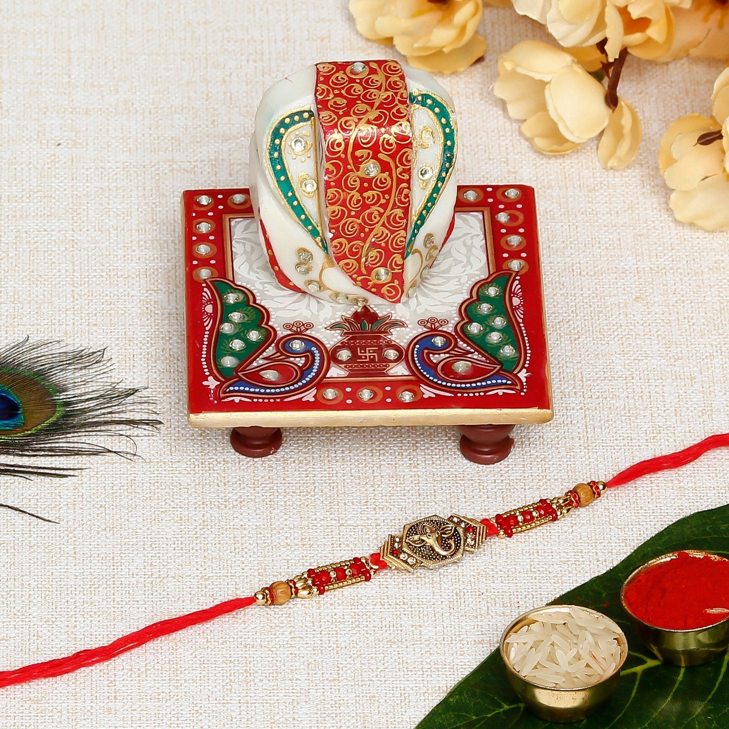 Designer Ganesha Rakhi with Lord Ganesha on Marble Chowki and Roli Chawal Pack