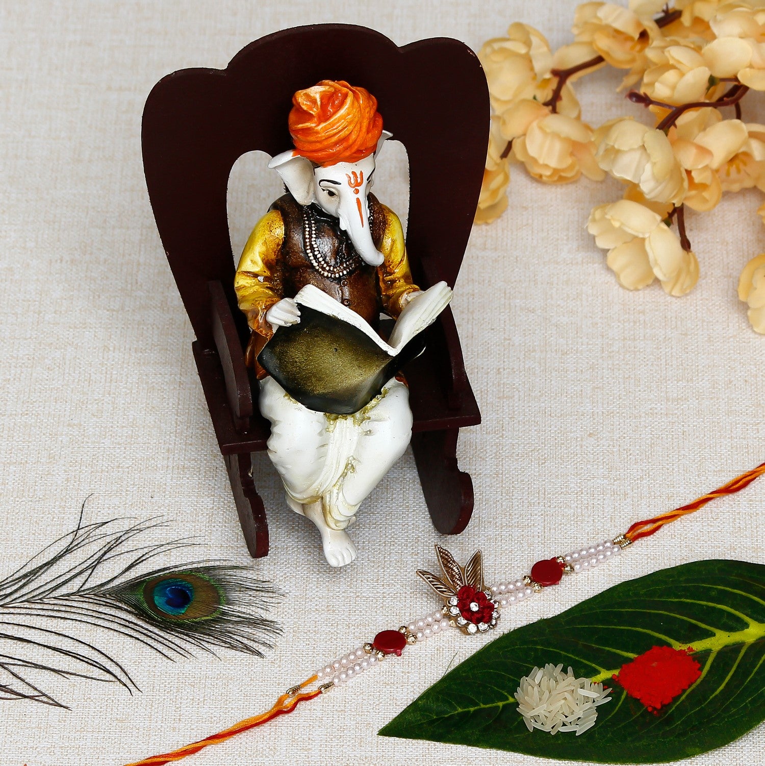 Designer  Handcrafted Rakhi with Lord Ganesha reading Book on Wooden Chair and Roli Chawal Pack