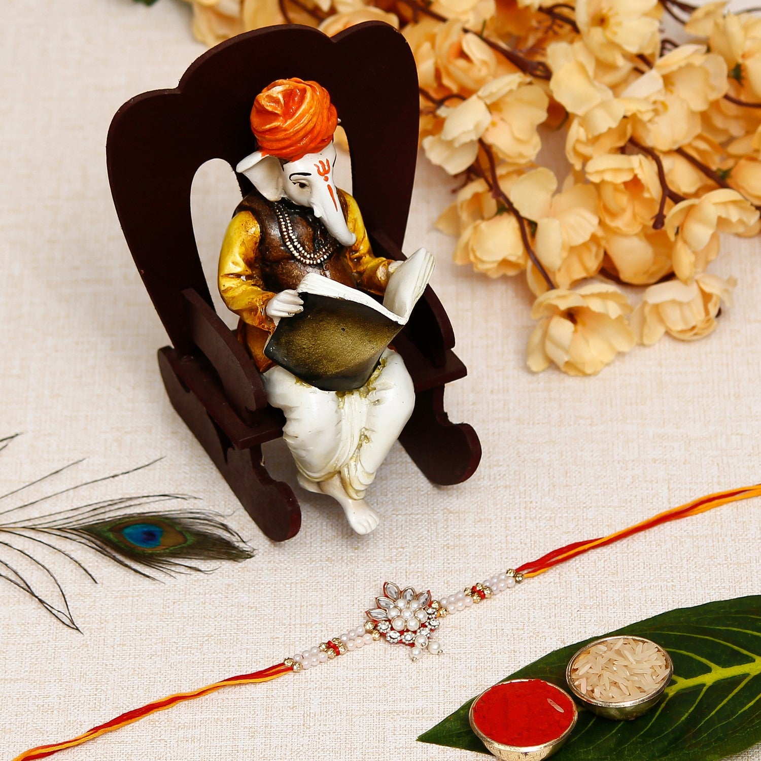Desginer Rakhi with Lord Ganesha reading Book on Wooden Chair and Roli Chawal Pack