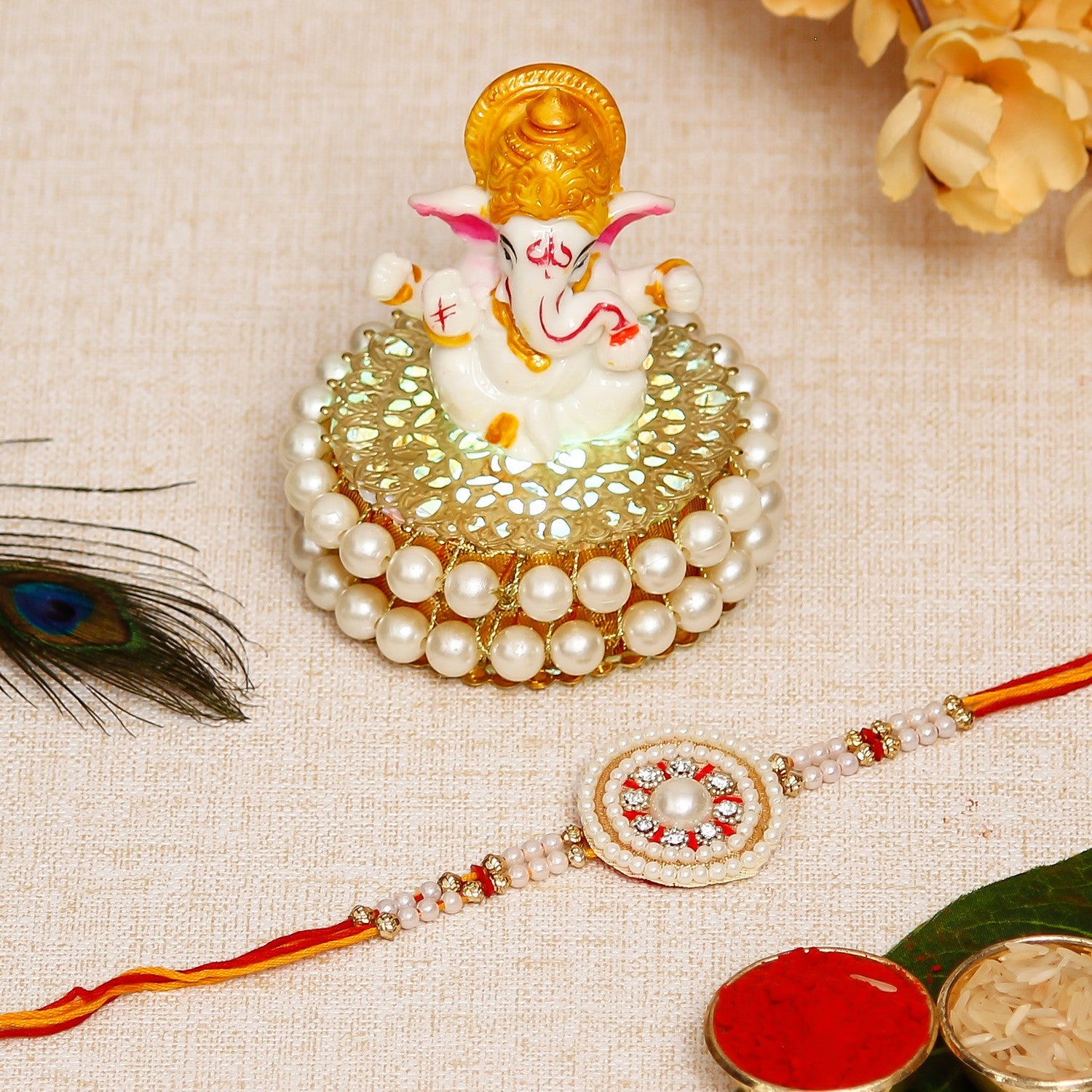 Desginer Stone and Pearl Rakhi with Lord Ganesha Idol on Decorative Handcrafted Plate for Home and Car and Roli Chawal Pack
