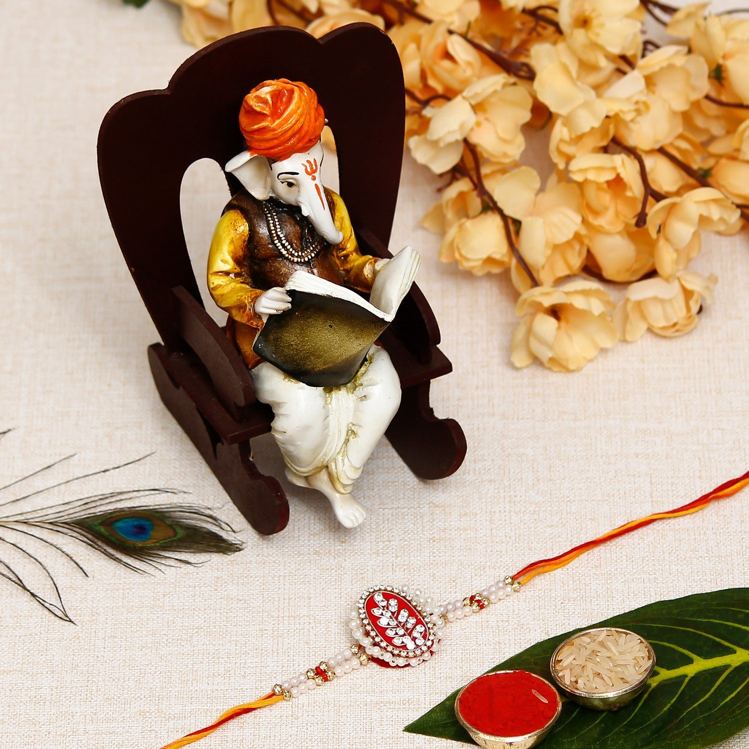 Designer Handcrafted Rakhi with Lord Ganesha reading Book on Wooden Chair and Roli Chawal Pack