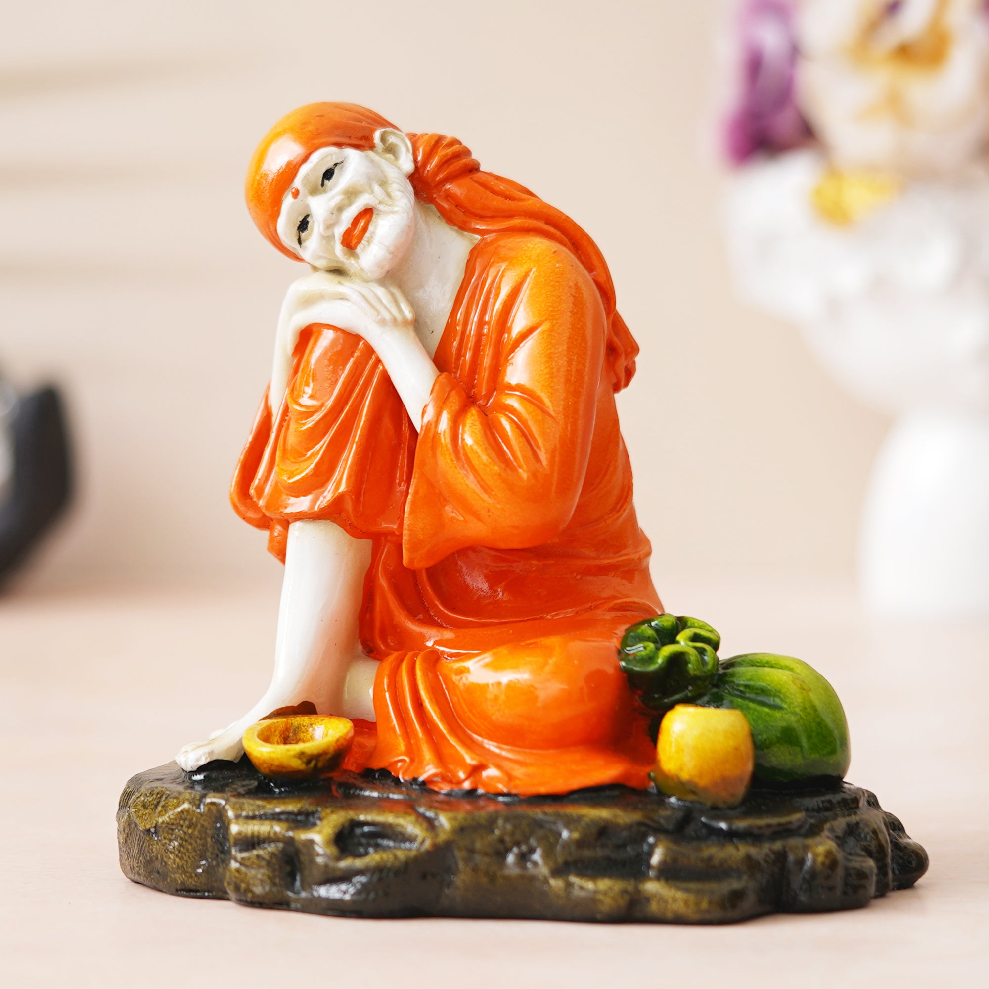 eCraftIndia Orange Polyresin Handcrafted Sai Baba Idol Resting on his Knee 1