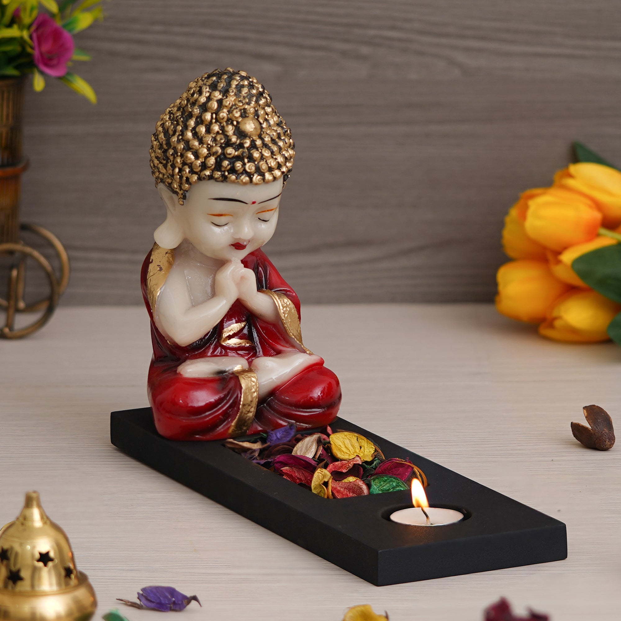 Red, Gold & Black Polyresin Praying Monk Showpiece with Rectangle Wooden Base, Fragranced Petals & Tealight