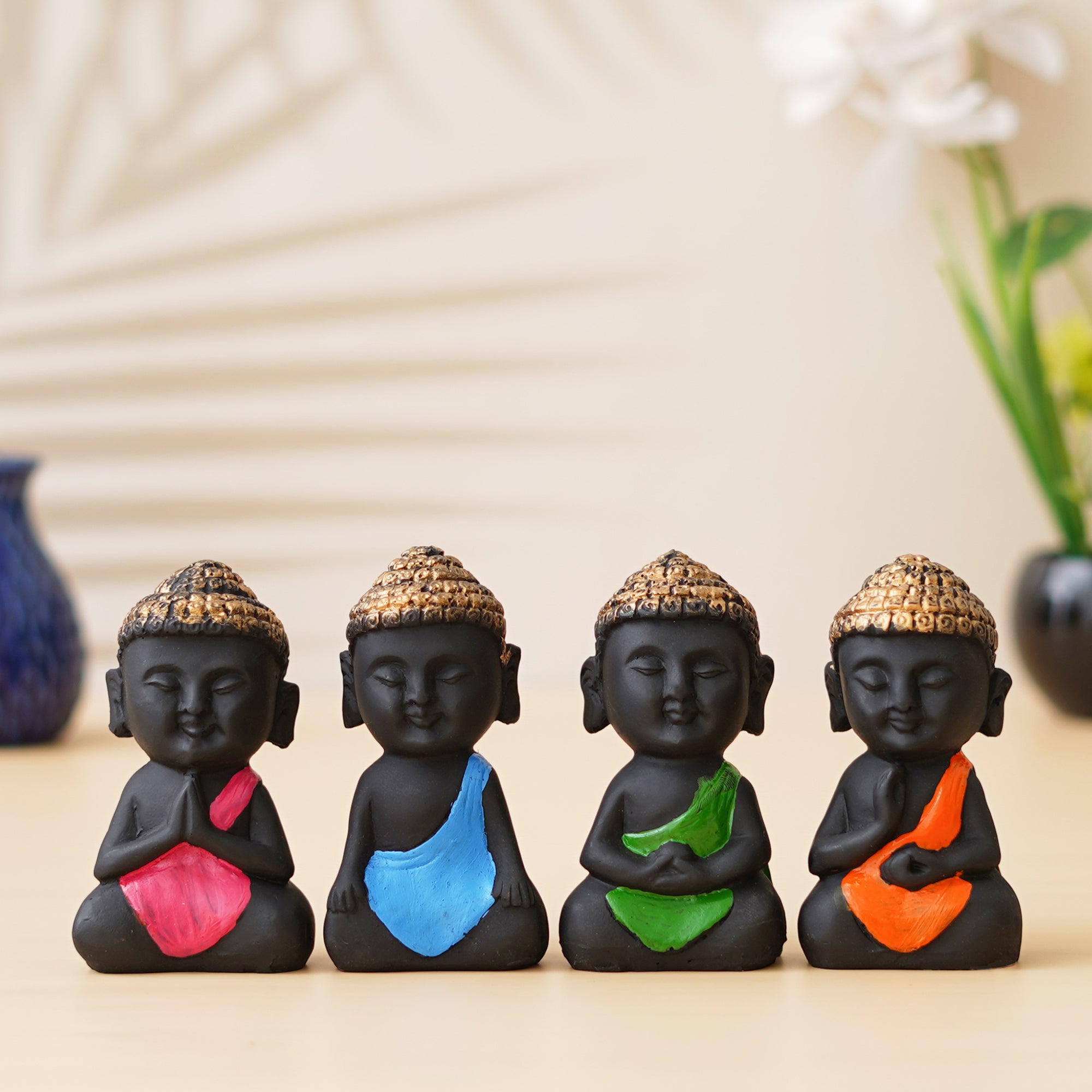 eCraftIndia Set Of 4 Pink, Blue, Green, Orange Polyresin Handcrafted Little Monk Buddha Statues