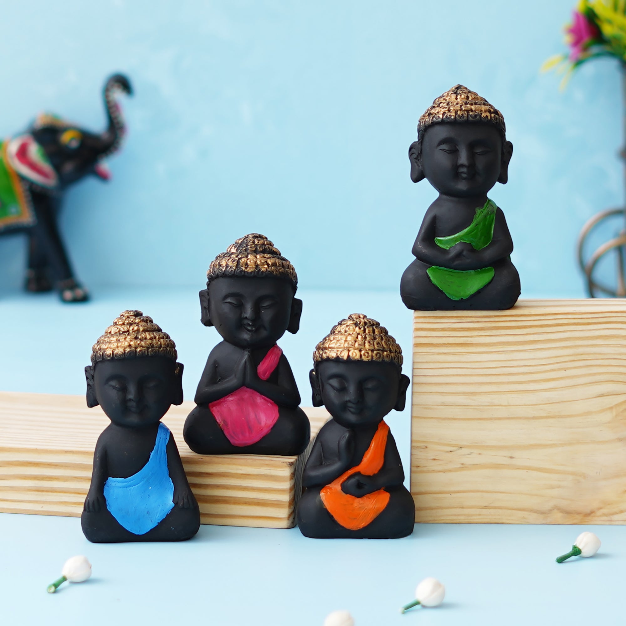 eCraftIndia Set Of 4 Pink, Blue, Green, Orange Polyresin Handcrafted Little Monk Buddha Statues 1