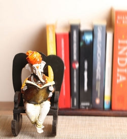 Designer Gota Patti Rakhi with Lord Ganesha reading Book on Wooden Chair and Roli Chawal Pack 3