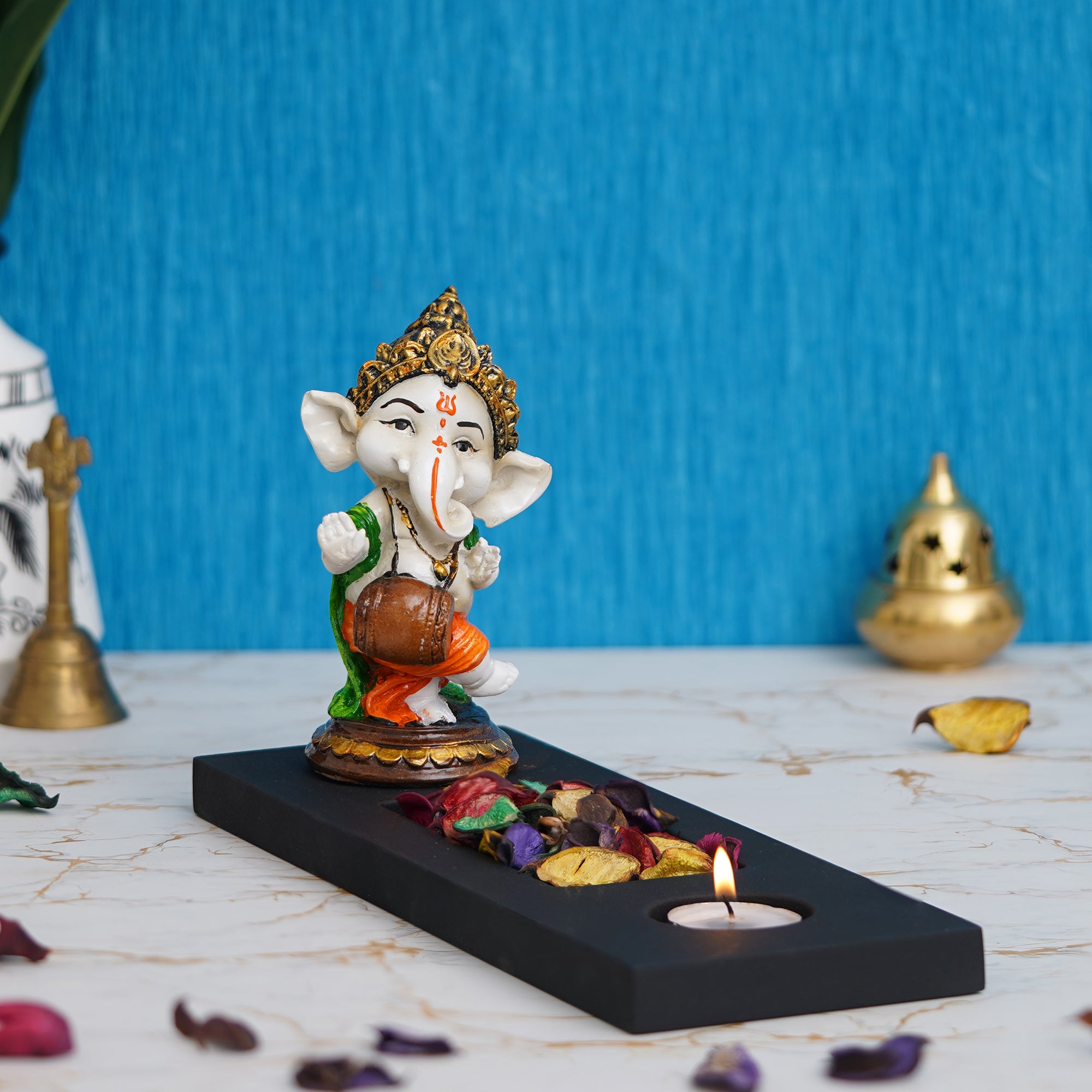 Orange, Brown, White & Black Polyresin Baal Ganesha Playing Dholak Showpiece with Rectangle Wooden Base, Fragranced Petals & Tealight 7