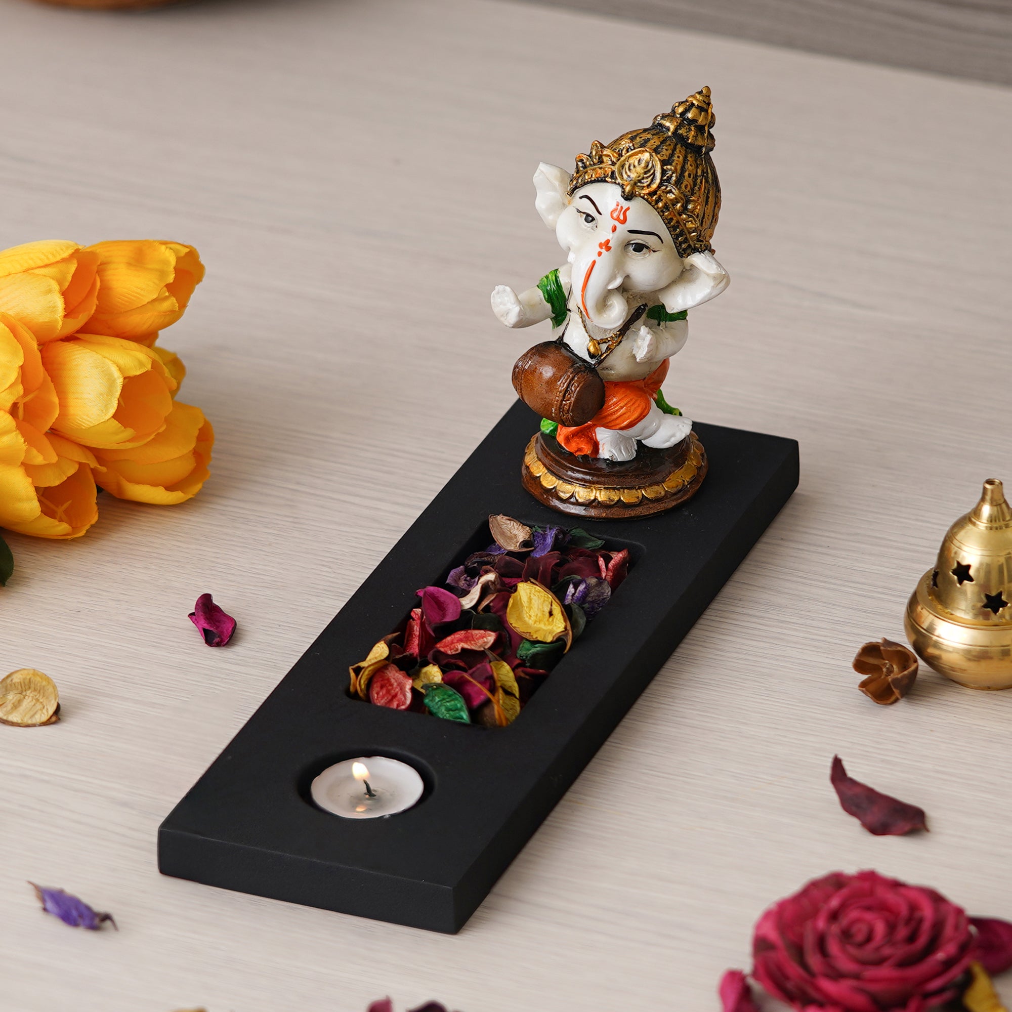 Orange, Brown, White & Black Polyresin Baal Ganesha Playing Dholak Showpiece with Rectangle Wooden Base, Fragranced Petals & Tealight 2