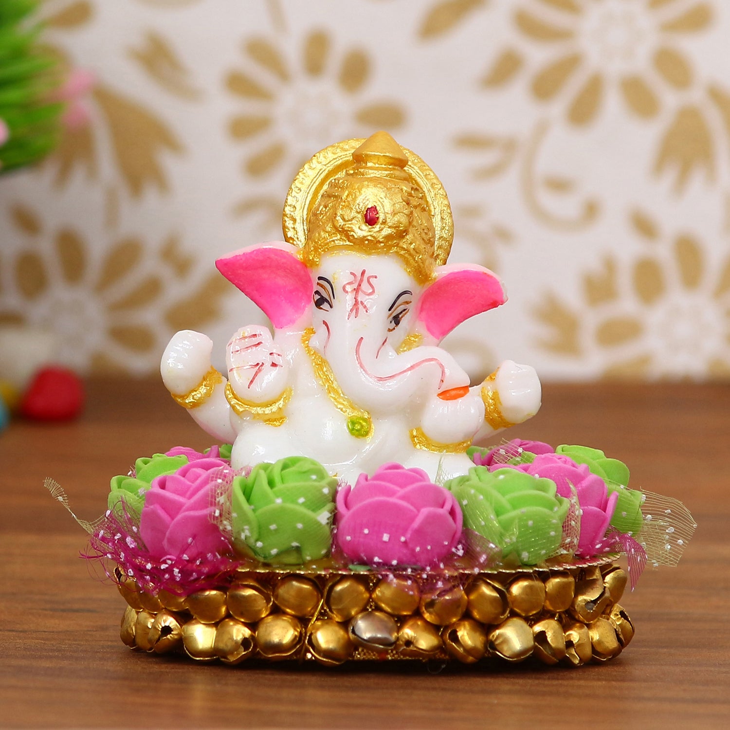 Golden and White Polyresin Lord Ganesha Idol on Decorative Pink and Green Flowers Plate