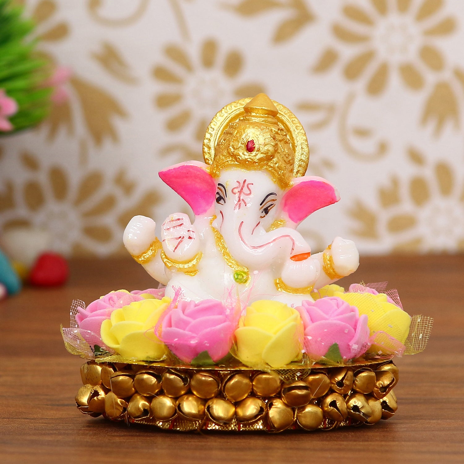 Golden and White Polyresin Lord Ganesha Idol on Decorative Handcrafted Plate with Pink and Yellow Flowers