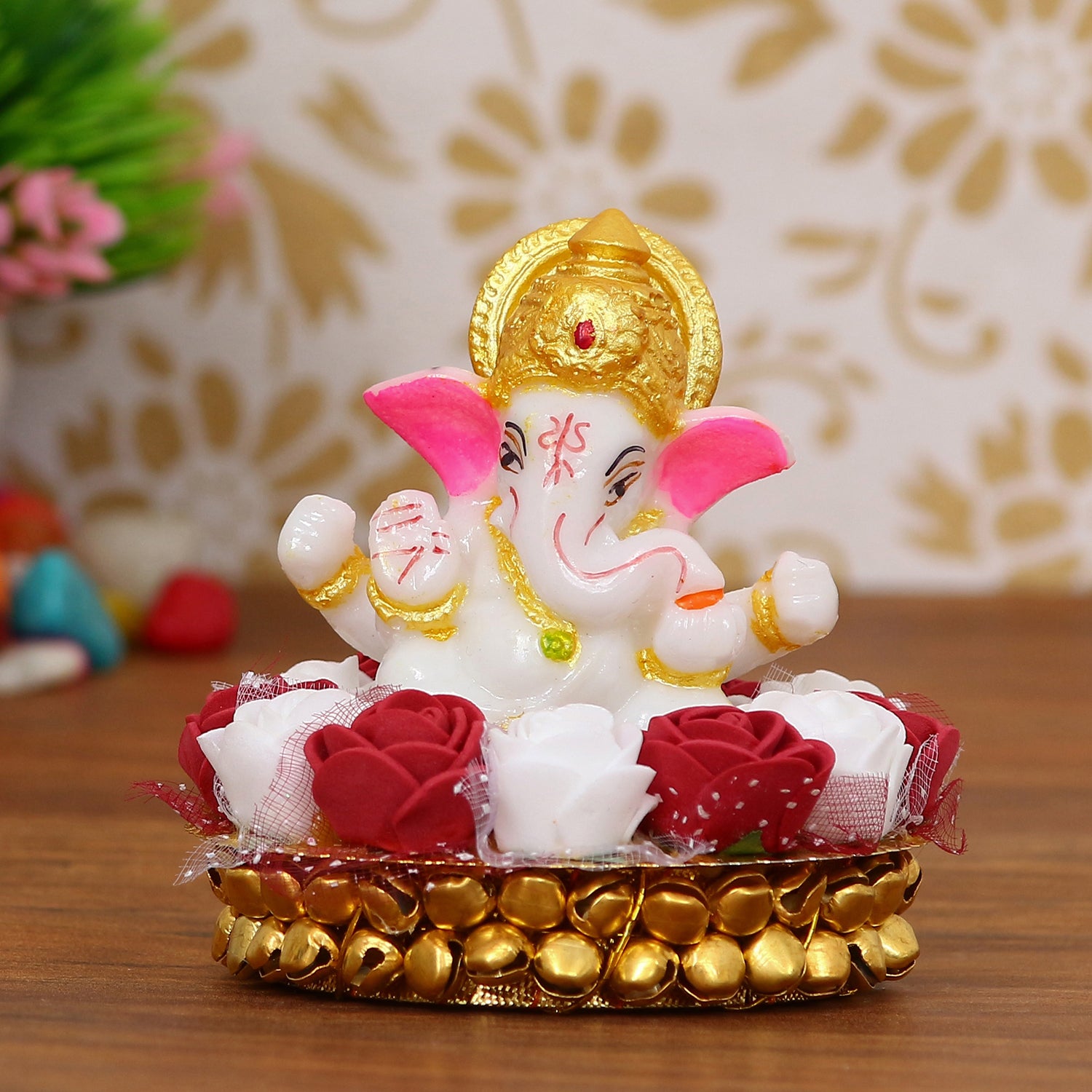 Golden and White Polyresin Lord Ganesha Idol on Decorative Handcrafted Plate with Red and White Flowers