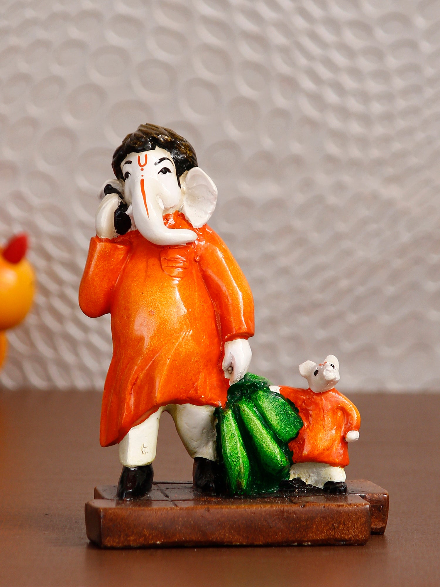Orange and Green Polyresin Handcrafted Lord Ganesha Idol Doing Shopping with Mushak 1
