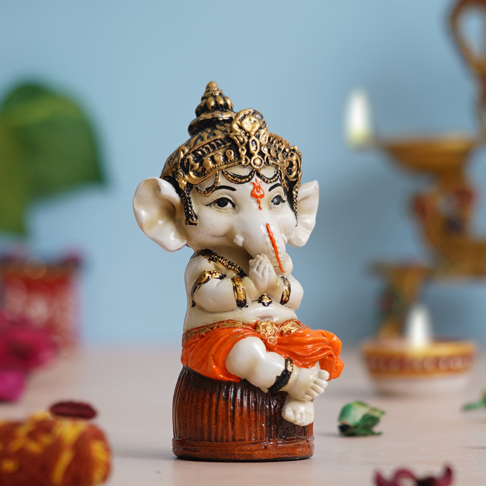 eCraftIndia Orange Polyresin Handcrafted Lord Ganesha Idol Sitting on Rock 1