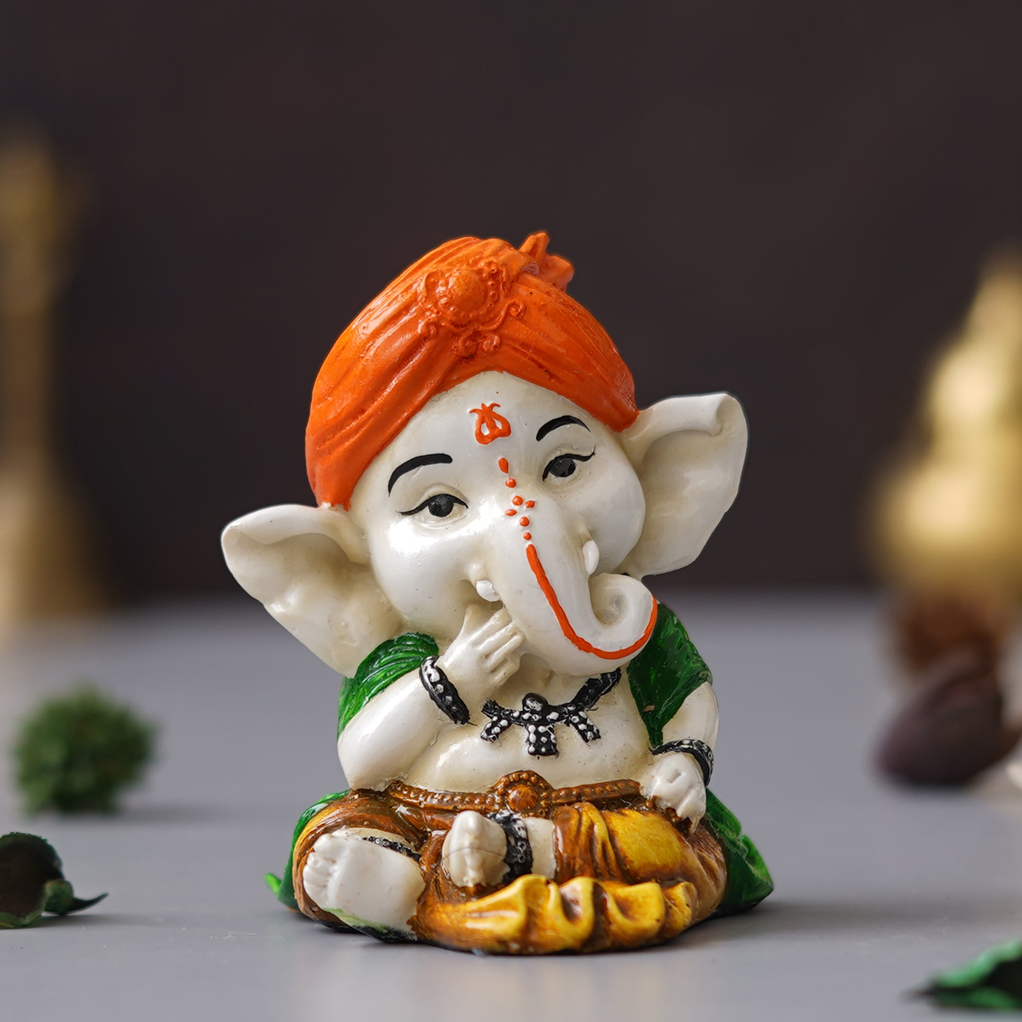 eCraftIndia Orange Polyresin Handcrafted Eating Lord Ganesha Idol while Sitting 4