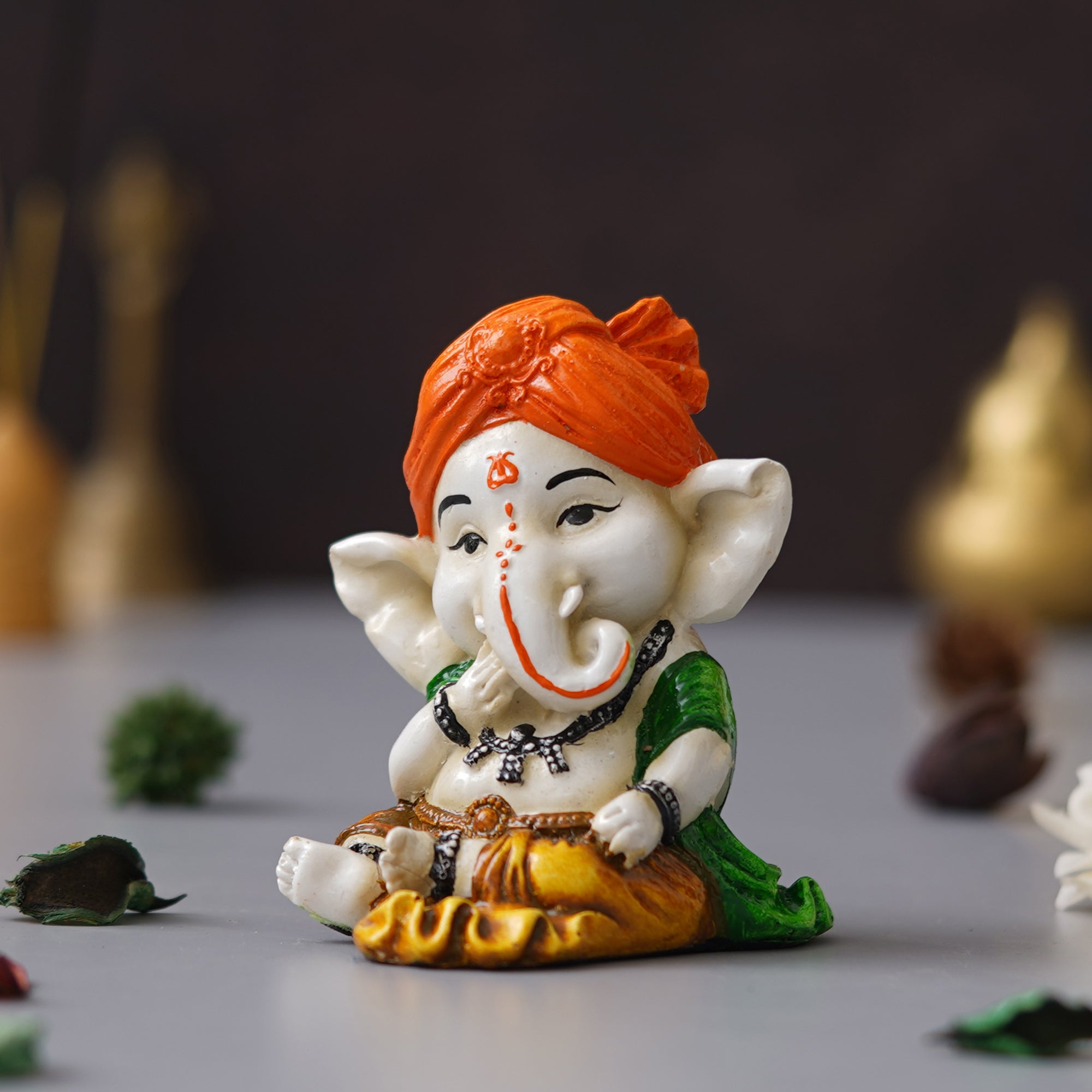 eCraftIndia Orange Polyresin Handcrafted Eating Lord Ganesha Idol while Sitting 5