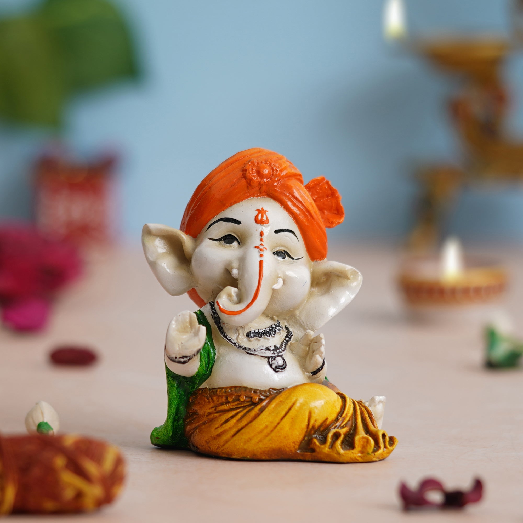 eCraftIndia Orange Polyresin Handcrafted Dancing Lord Ganesha Idol while Sitting