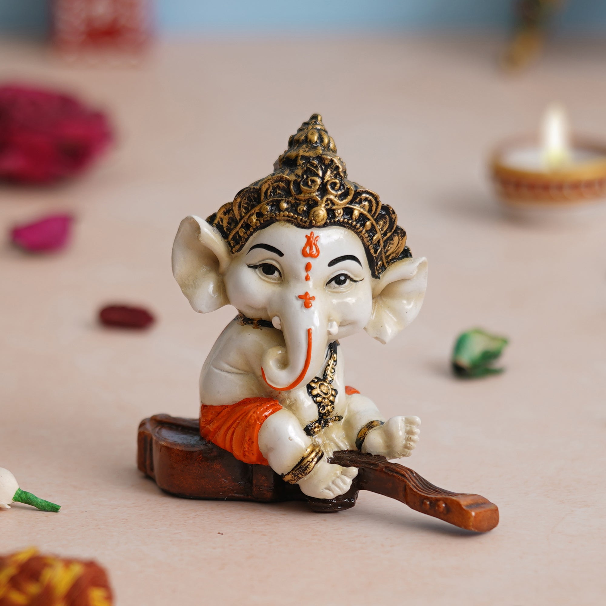 eCraftIndia Orange Polyresin Decorated Lord Ganesha Idol Sitting on Veena Musical Instrument