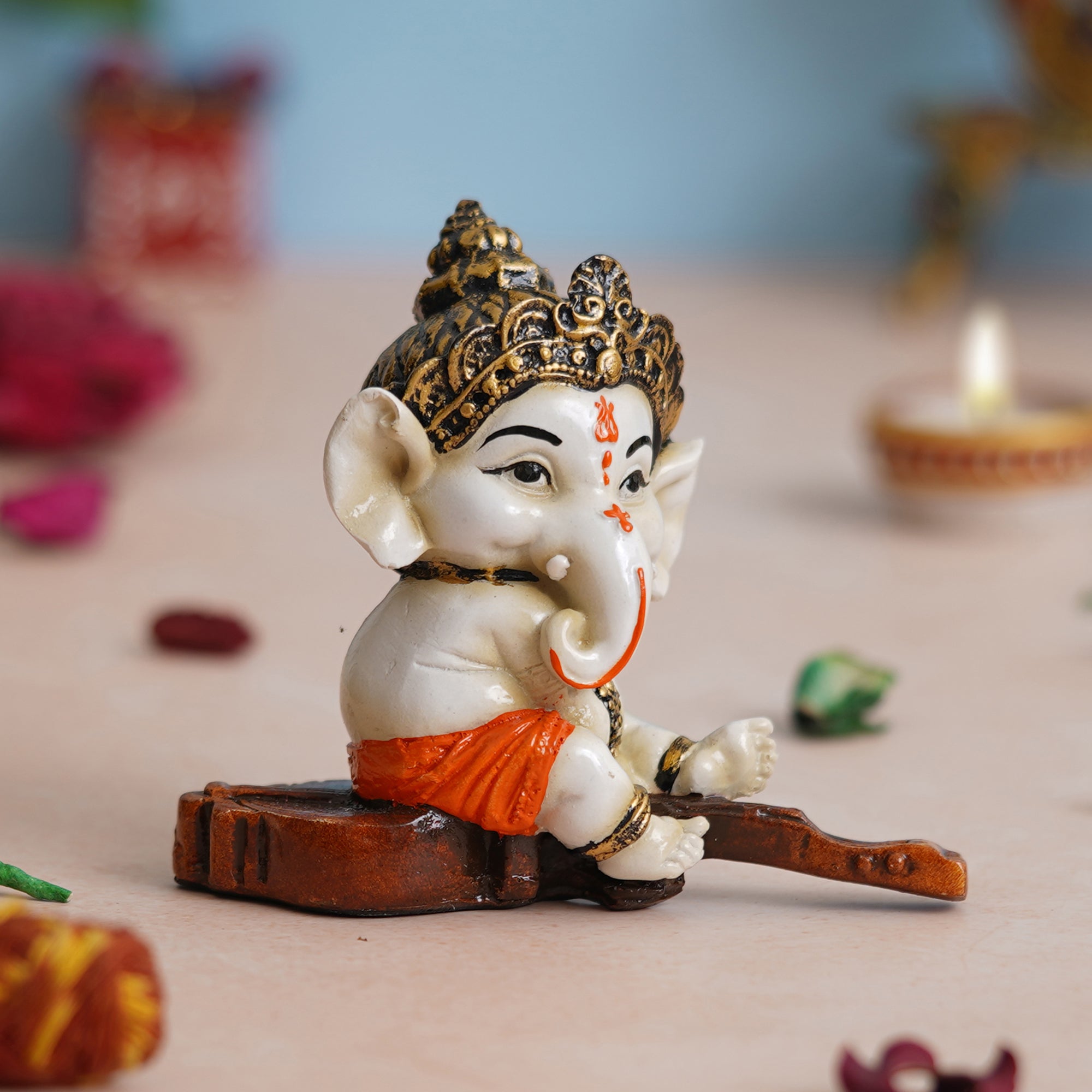 eCraftIndia Orange Polyresin Decorated Lord Ganesha Idol Sitting on Veena Musical Instrument 1