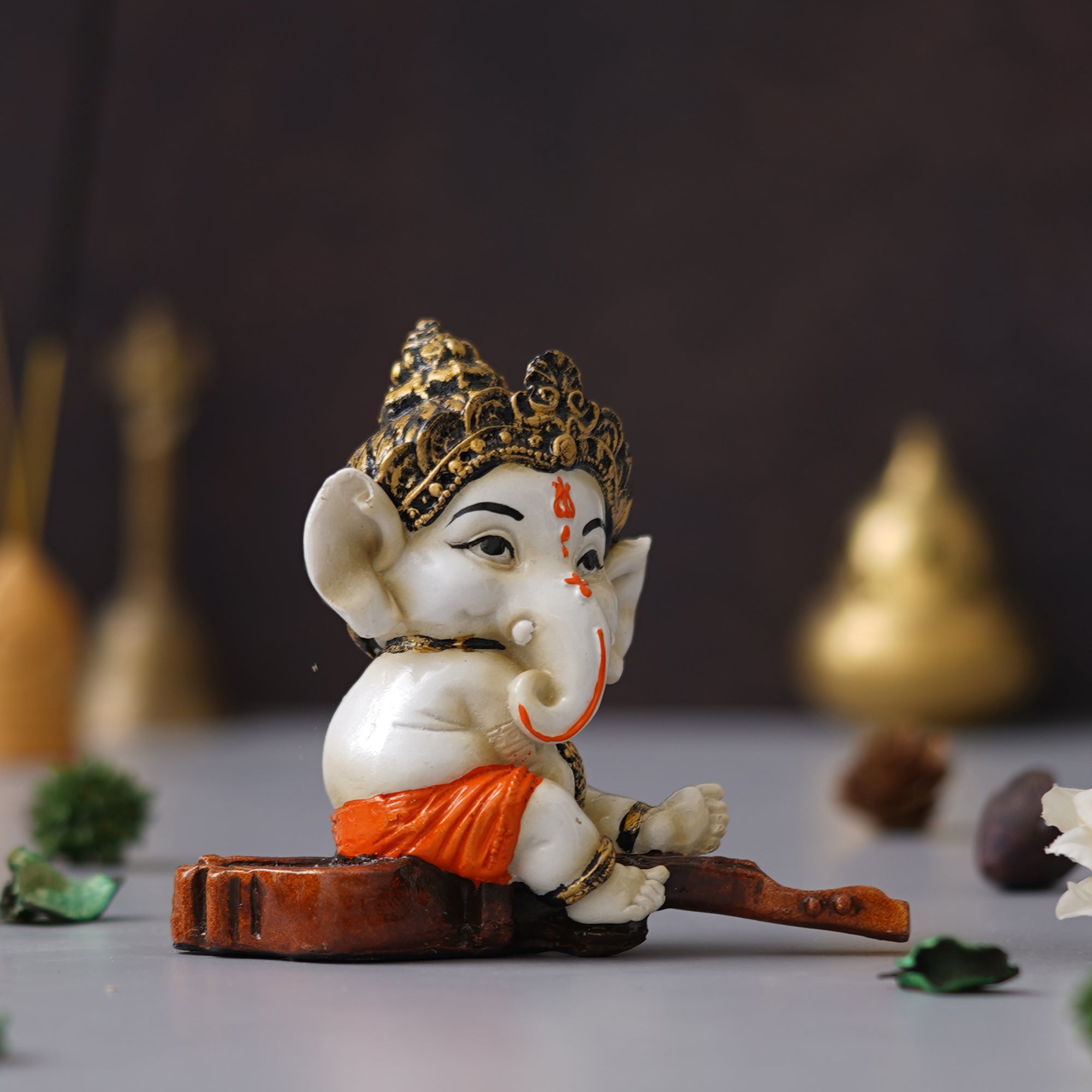 eCraftIndia Orange Polyresin Decorated Lord Ganesha Idol Sitting on Veena Musical Instrument 4
