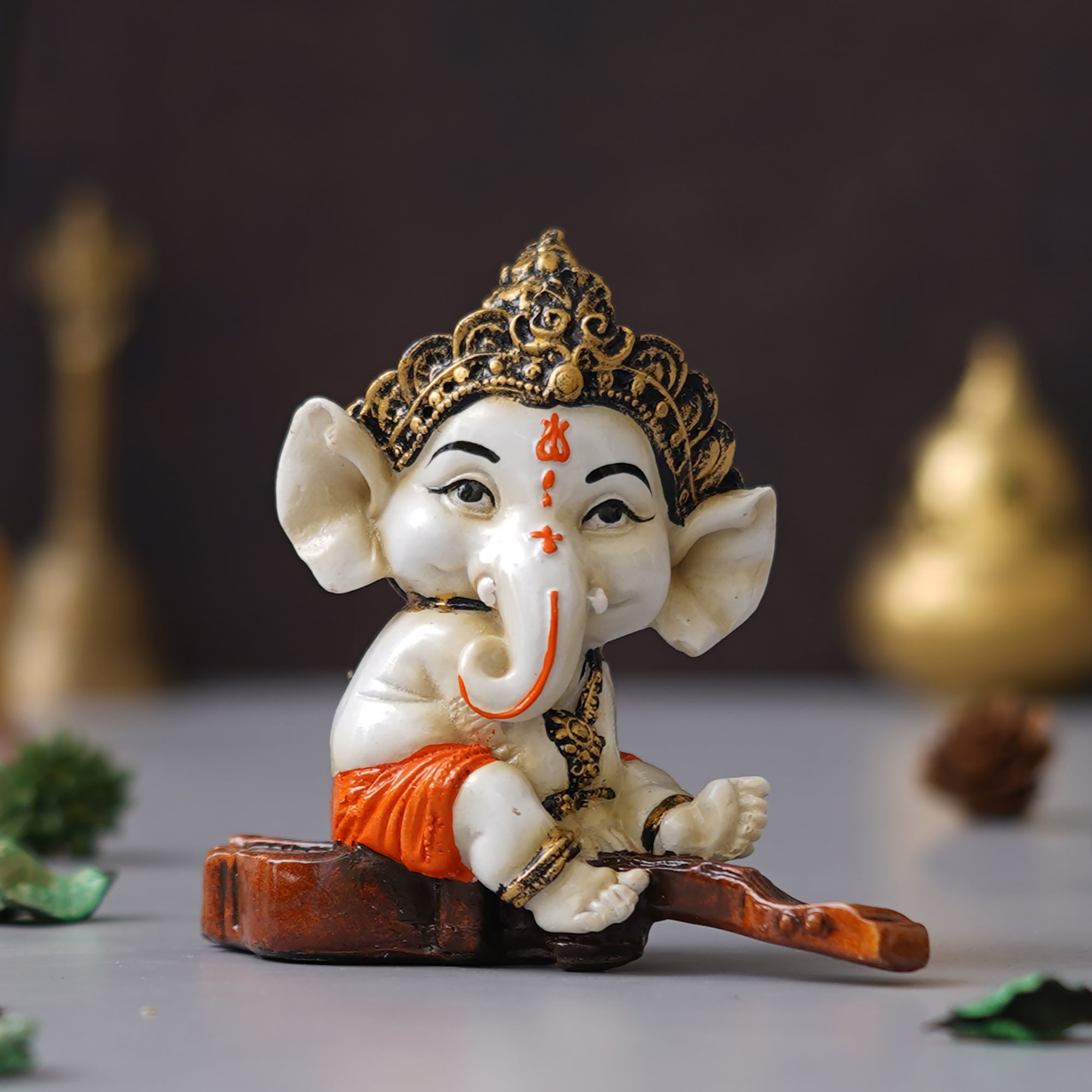 eCraftIndia Orange Polyresin Decorated Lord Ganesha Idol Sitting on Veena Musical Instrument 5