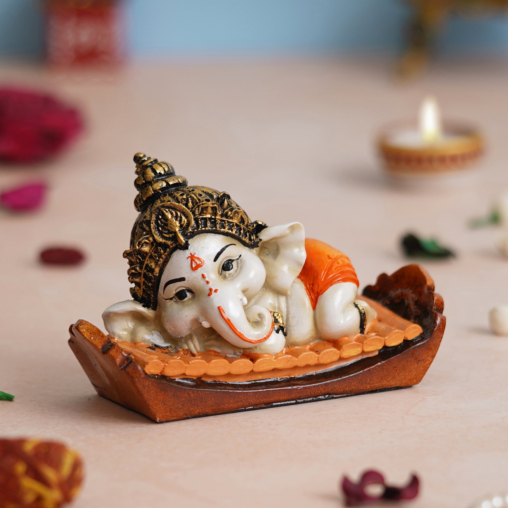 eCraftIndia Orange Handcrafted Polyresin Decorated Lord Ganesha Idol Sitting on Musical Instrument
