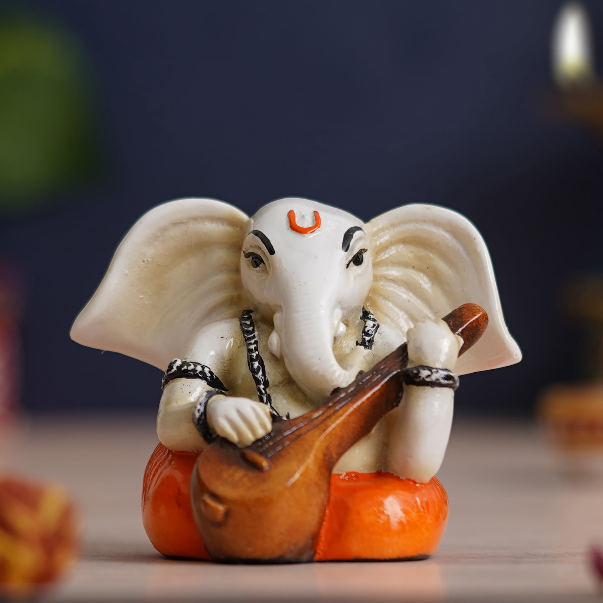 eCraftIndia White & Orange Polyresin Handcrafted Lord Ganesha Idol Playing Veena