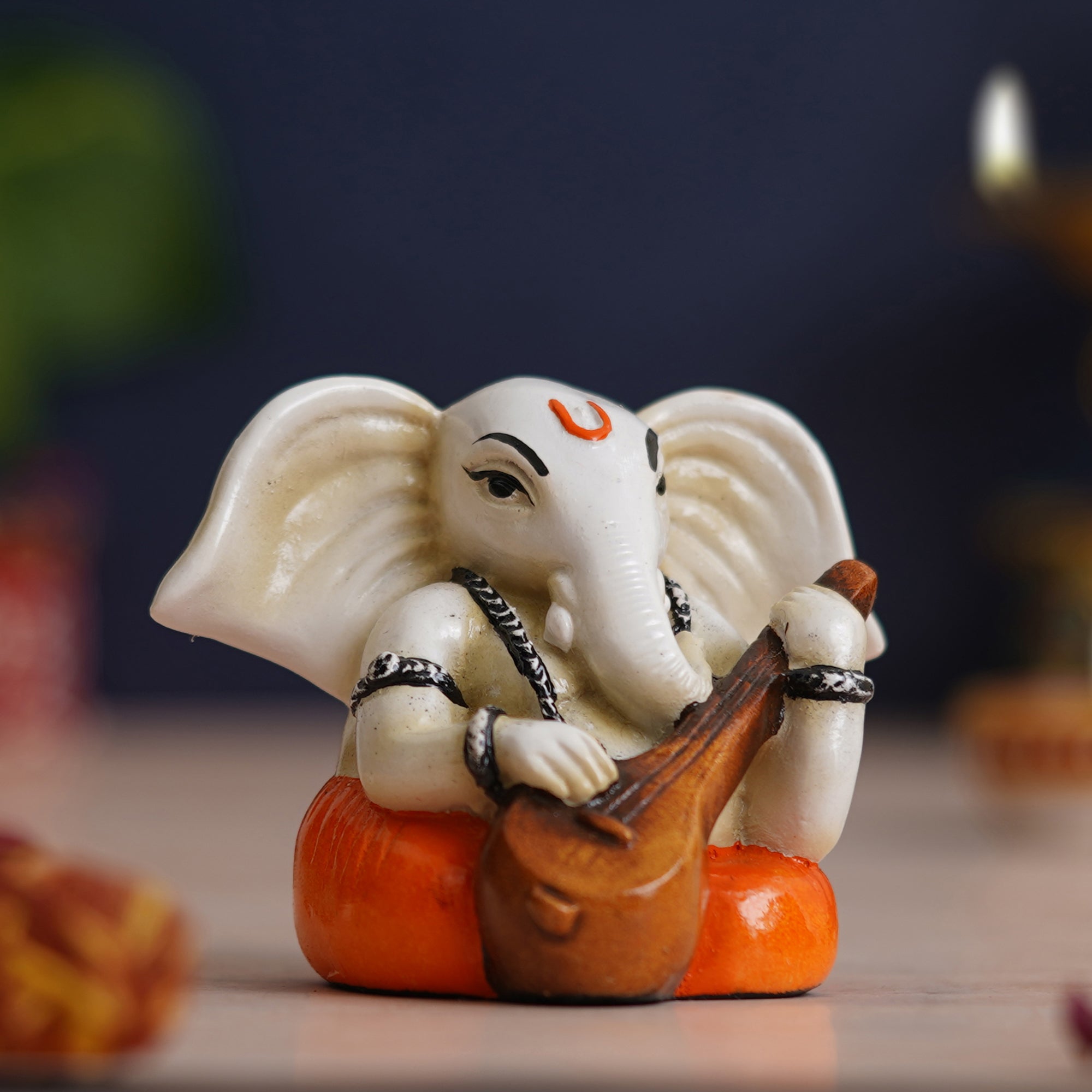 eCraftIndia White & Orange Polyresin Handcrafted Lord Ganesha Idol Playing Veena 1
