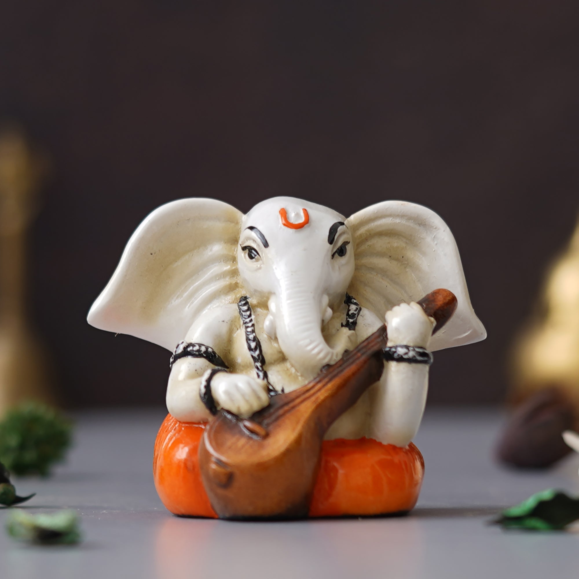 eCraftIndia White & Orange Polyresin Handcrafted Lord Ganesha Idol Playing Veena 4