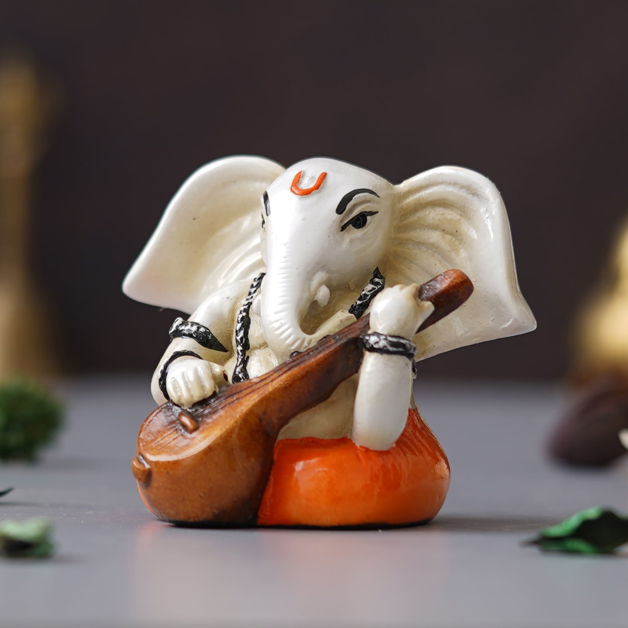 eCraftIndia White & Orange Polyresin Handcrafted Lord Ganesha Idol Playing Veena 5