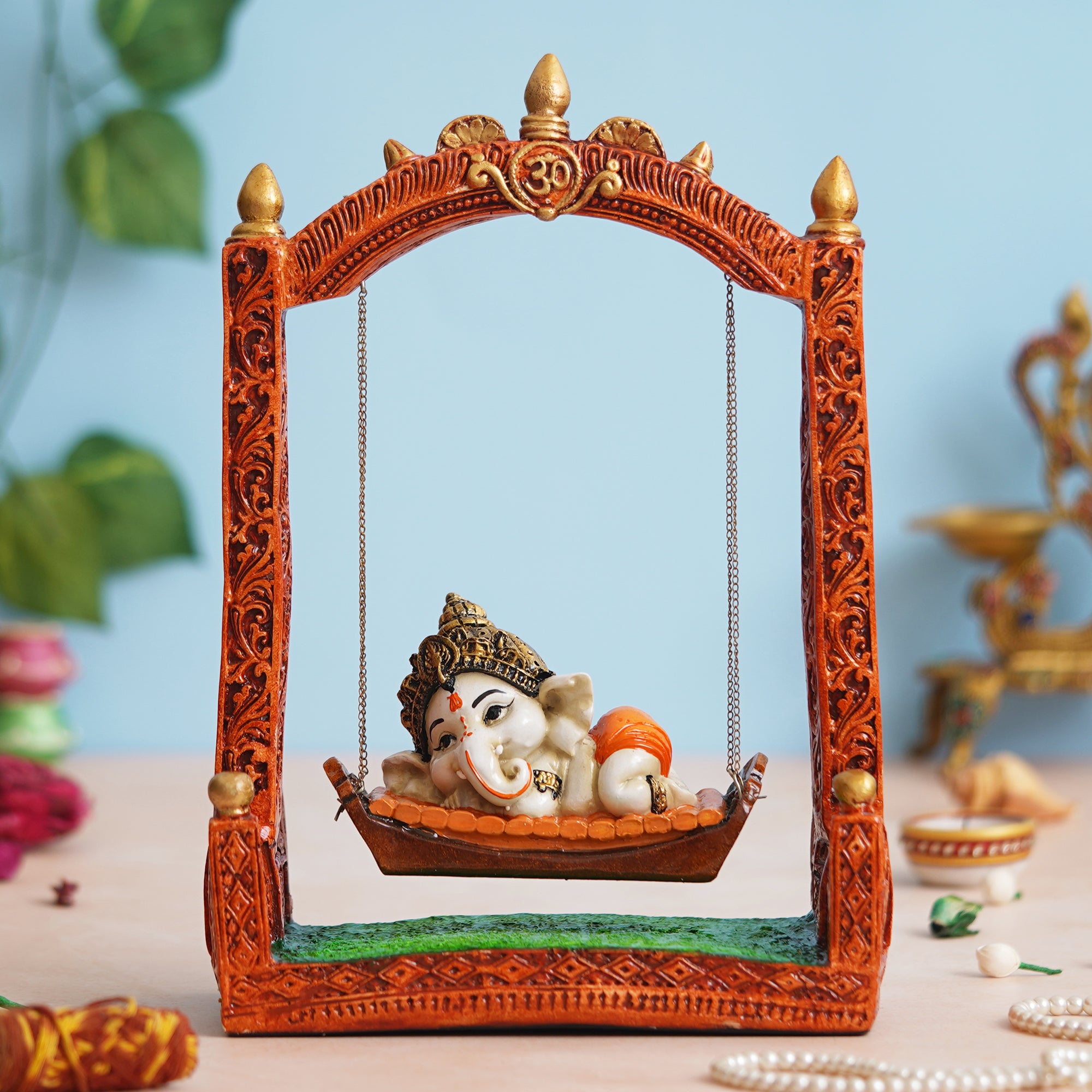 eCraftIndia Multicolor Polyresin Lord Ganesha Idol Resting On A Swing Decorative Showpiece