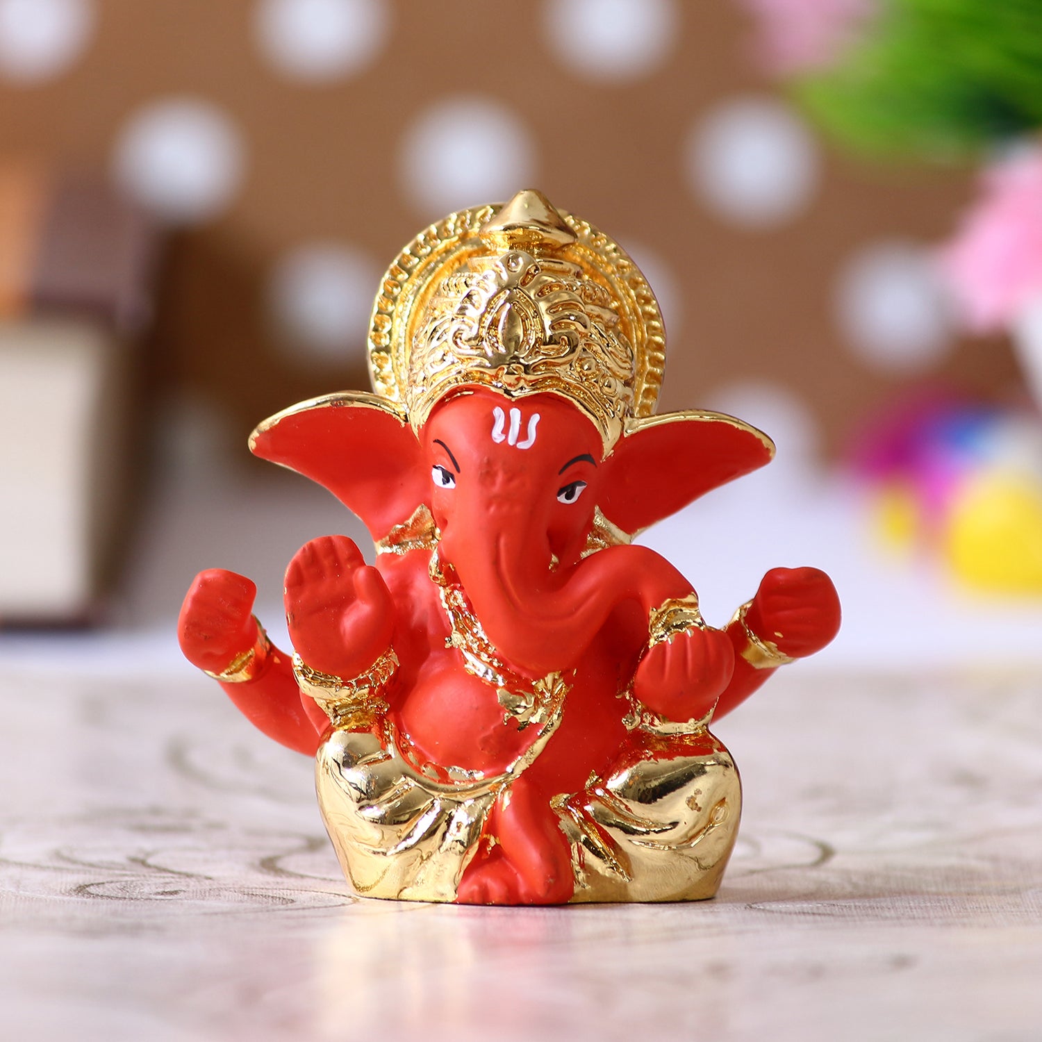 Gold Plated Orange Polyresin Lord Ganesha Idol for Home, Temple, Office and Car Dashboard