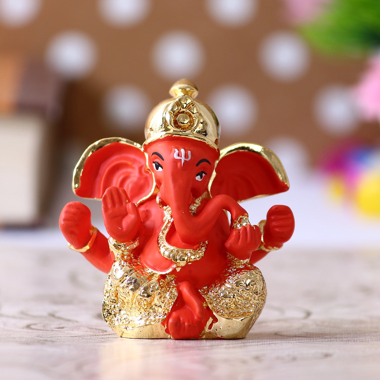Gold Plated Orange Polyresin Ganesha Idol for Home, Temple, Office and Car Dashboard