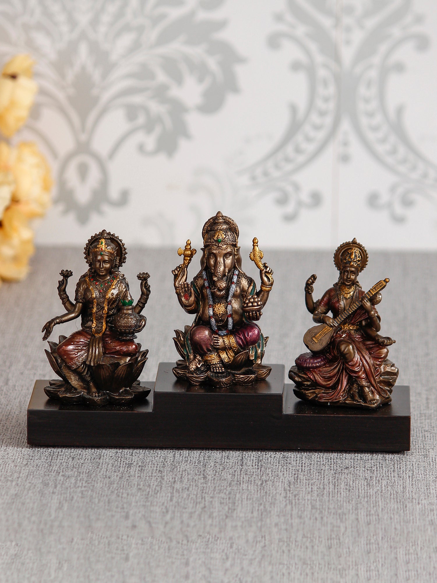 Brown Polyresin and Bronze Lakshmi Ganesha Saraswati Idols on Base 1